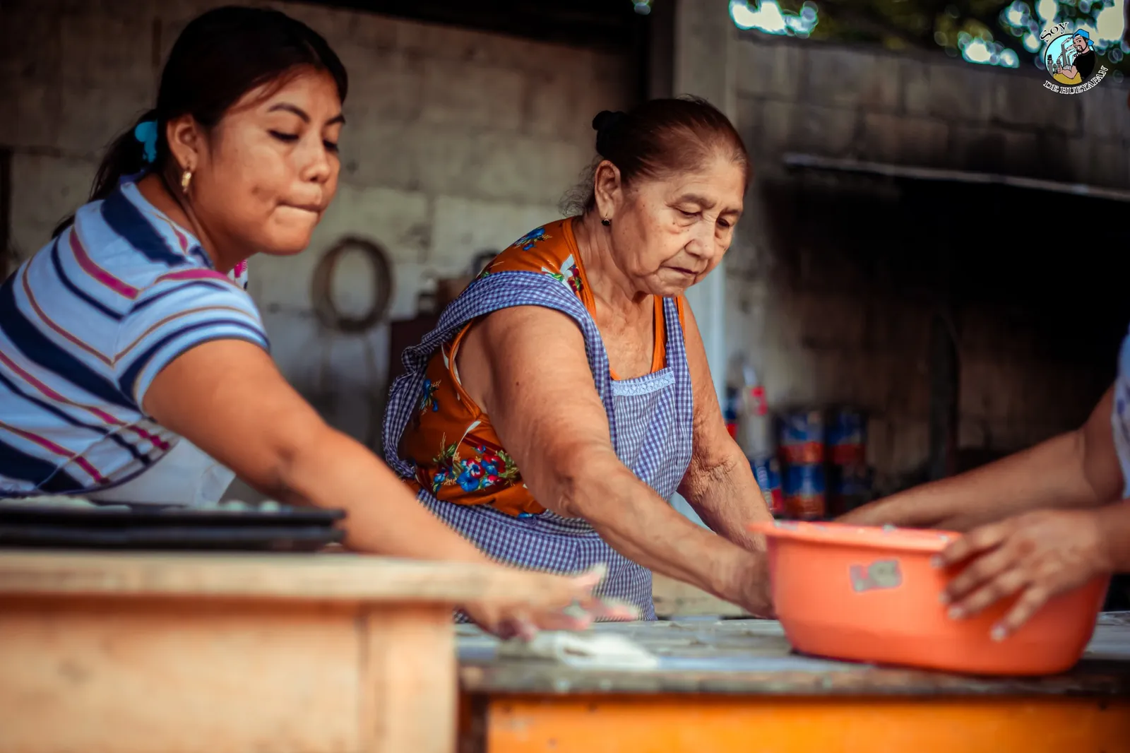 Women working side by side in a community kitchen