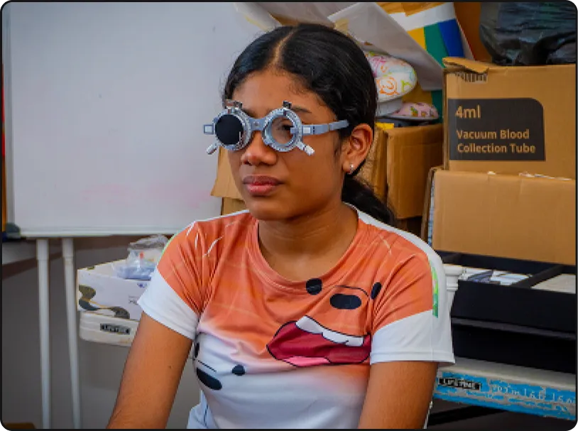 A community member receiving an eye examination