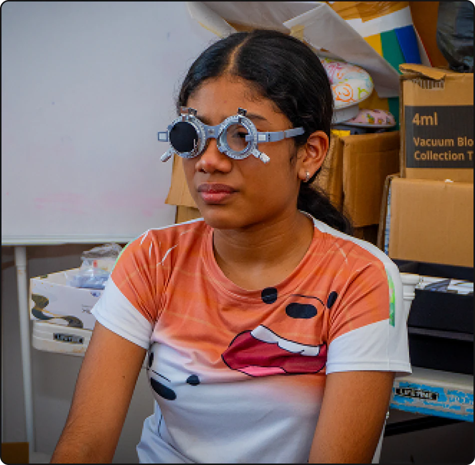A community member receiving an eye examination