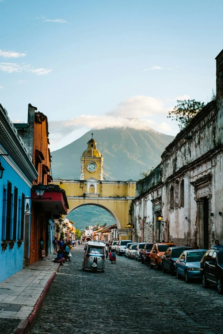 A colorful colonial street framed by a yellow archway