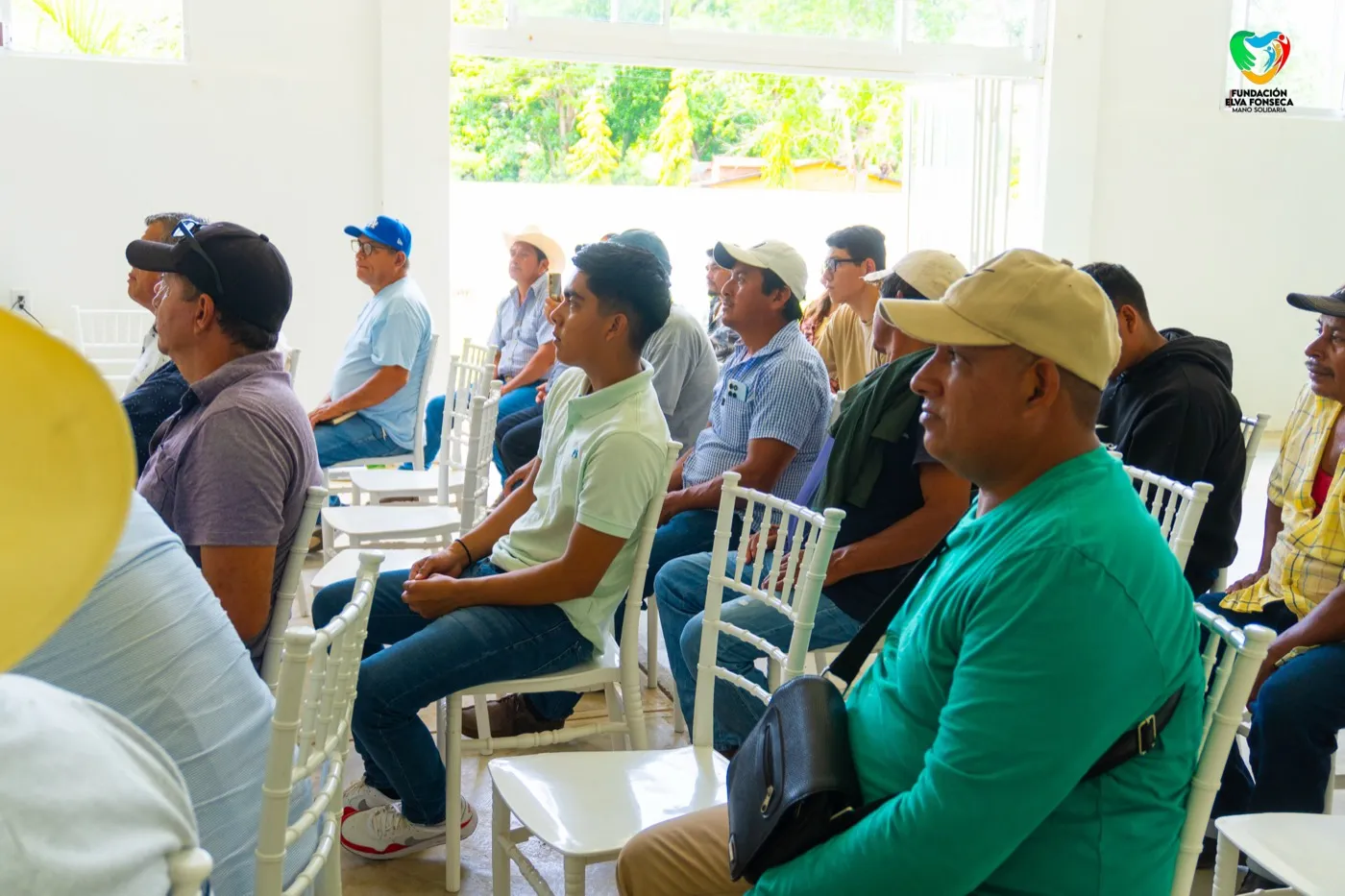A group of volunteers seated indoors during a training session